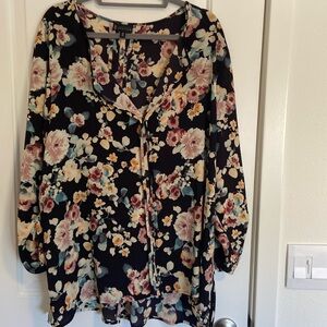 3X v-neck long sleeve blouse with a black background and colorful flowers